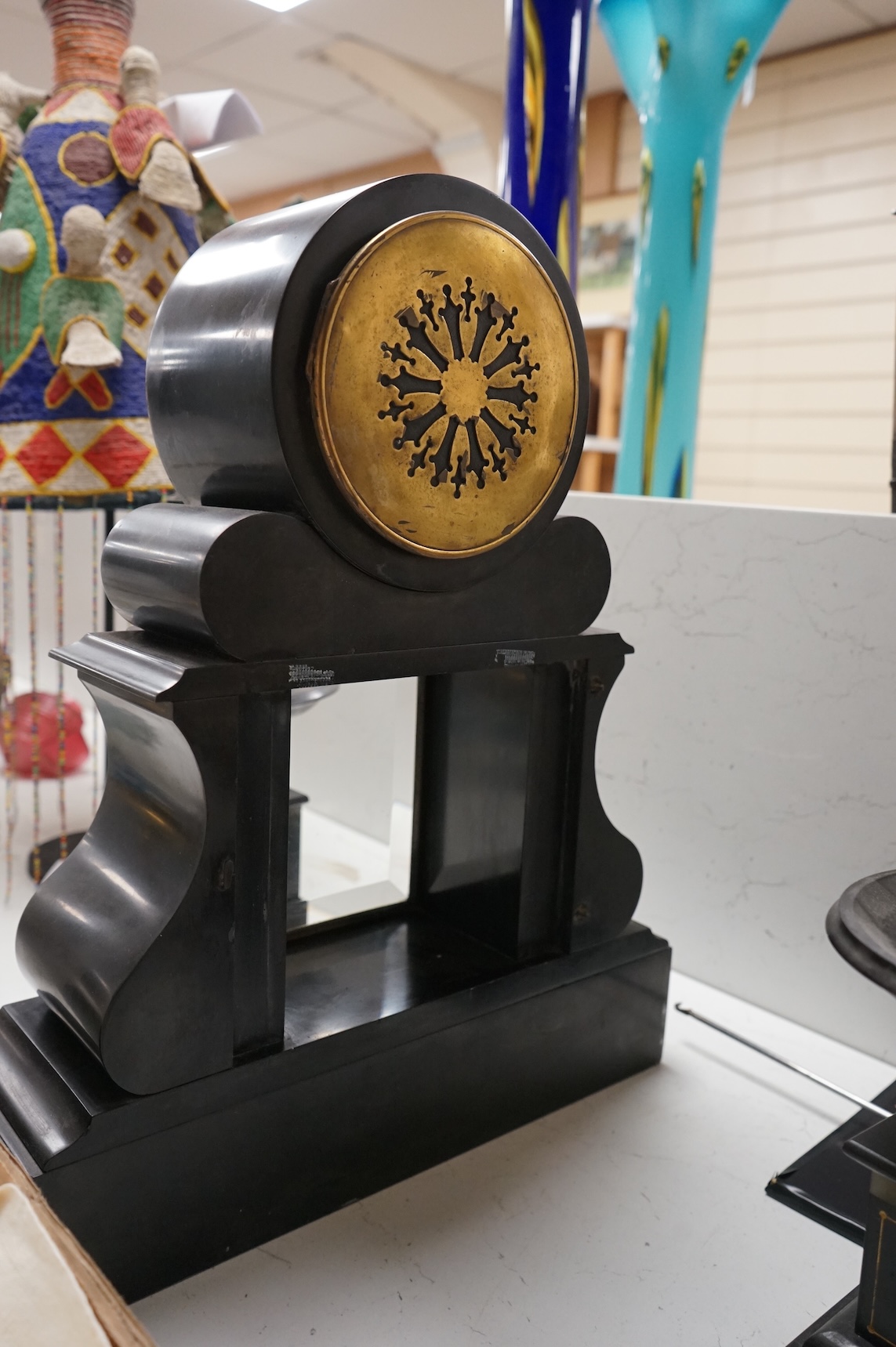 A Victorian slate clock garniture with enamelled chapter ring and mercury pendulum, 47cm high
